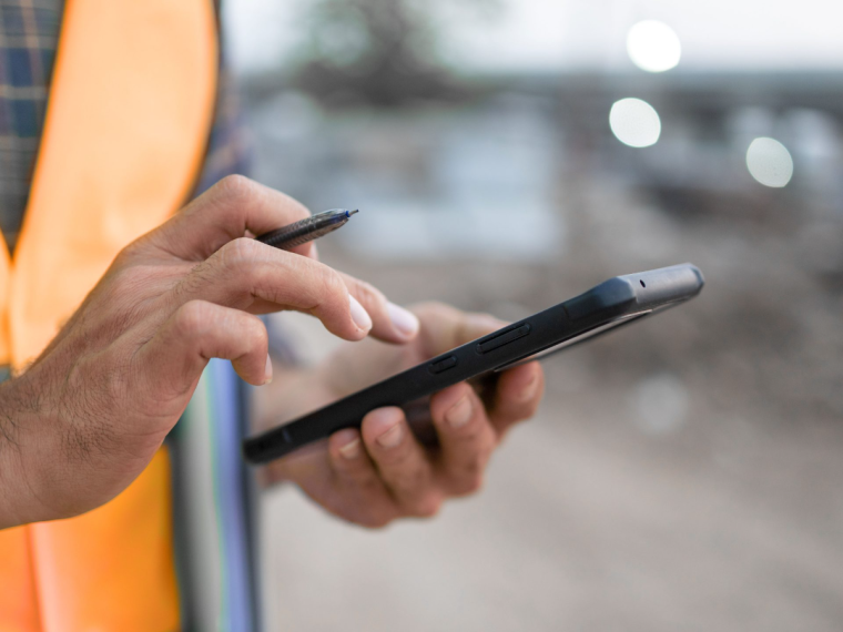 Littéralis, un zoom sur un téléphone dans les mains d'une personne sur un chantier
